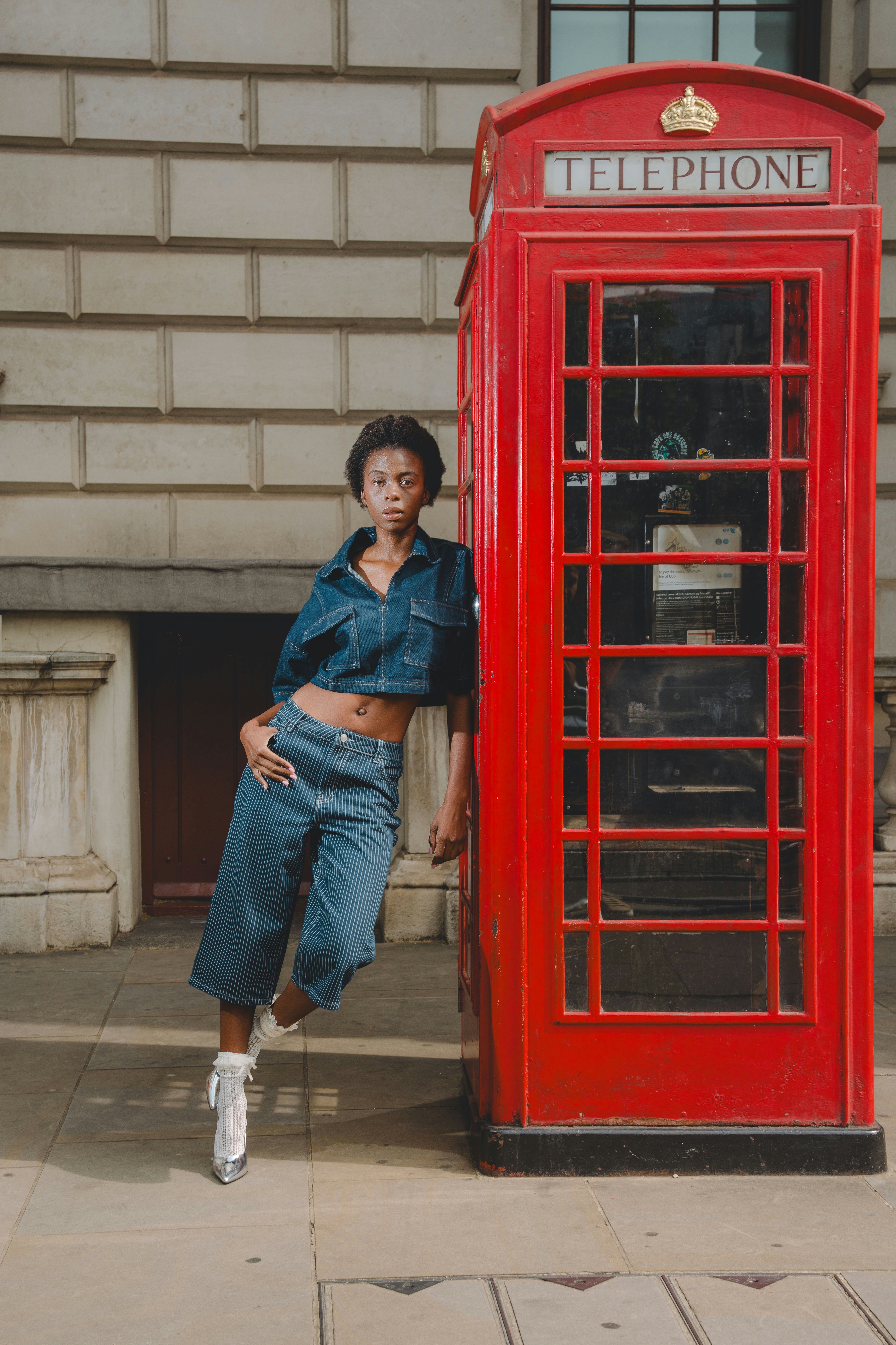 woman leaning on phone box