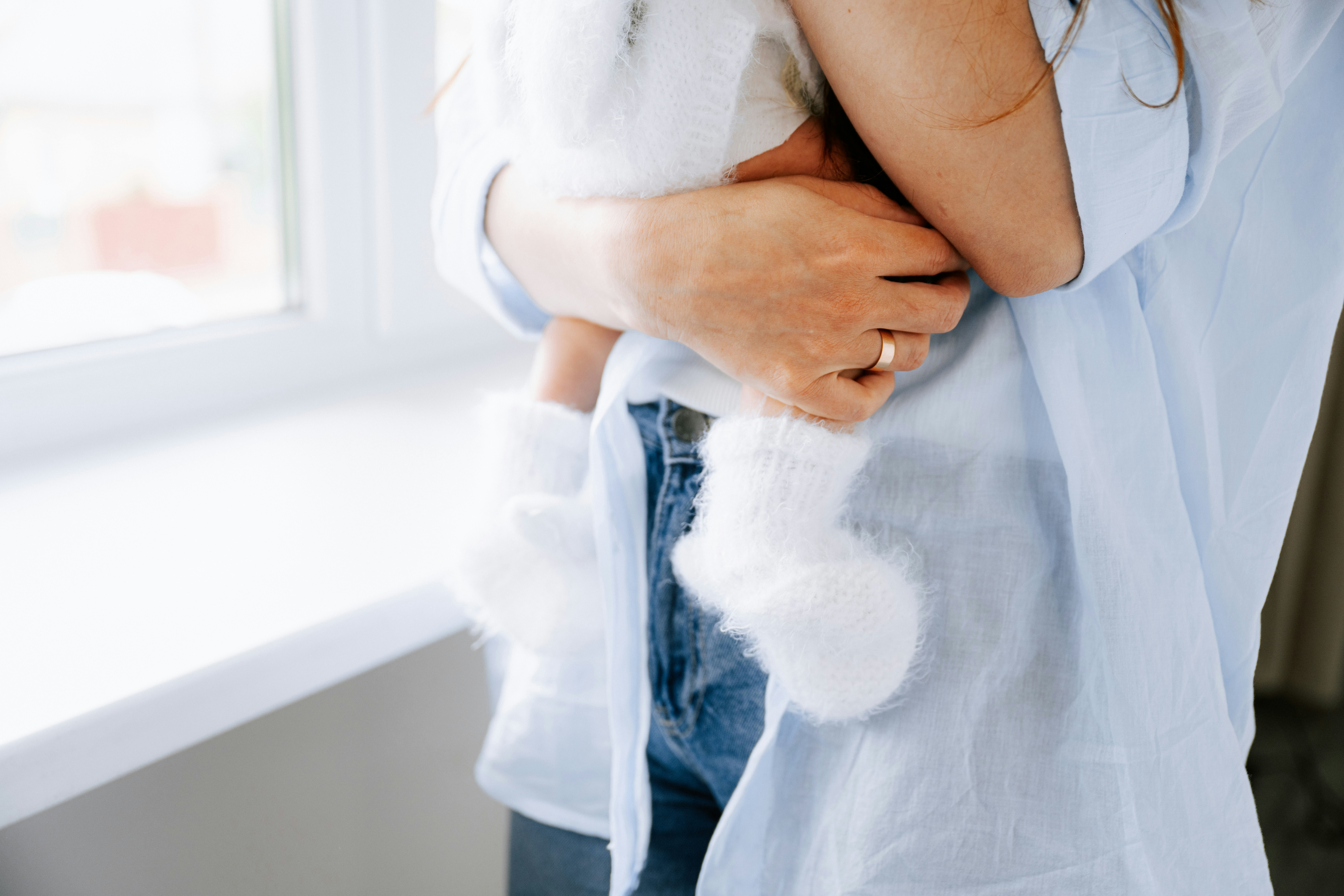 womean wearing ring carrying a baby